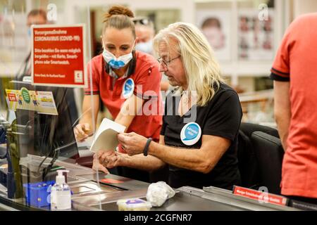 Potsdam, Germany. 10th Sep, 2020. Bernd Römer (Karat) is committed to helping socially disadvantaged people, and for the 'Deutschland rundet auf' campaign the band members sit at the cash desk and collect money in the Kaufland department store at Potsdam's main station. Credit: Gerald Matzka/dpa-Zentralbild/ZB/dpa/Alamy Live News Stock Photo