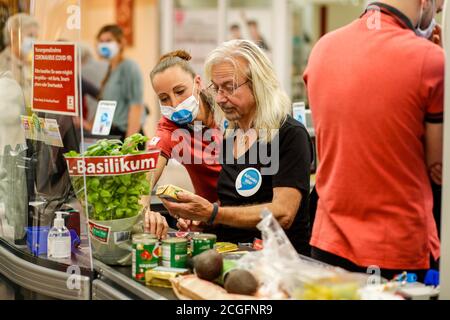 Potsdam, Germany. 10th Sep, 2020. Bernd Römer (Karat) is committed to helping socially disadvantaged people, and for the 'Deutschland rundet auf' campaign the band members sit at the cash desk and collect money in the Kaufland department store at Potsdam's main station. Credit: Gerald Matzka/dpa-Zentralbild/ZB/dpa/Alamy Live News Stock Photo