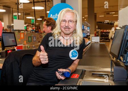 Potsdam, Germany. 10th Sep, 2020. Bernd Römer (Karat) is committed to helping socially disadvantaged people, and for the 'Deutschland rundet auf' campaign the band members sit at the cash desk and collect money in the Kaufland department store at Potsdam's main station. Credit: Gerald Matzka/dpa-Zentralbild/ZB/dpa/Alamy Live News Stock Photo