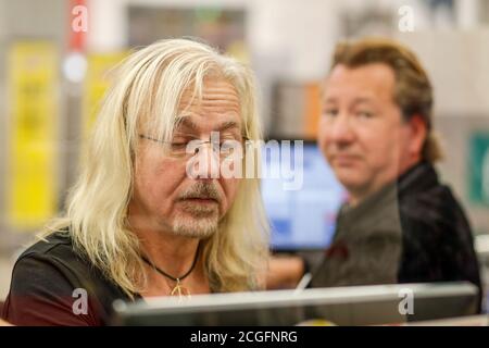 Potsdam, Germany. 10th Sep, 2020. Bernd Römer (l) and Claudius Dreilich (Karat) are committed to helping socially disadvantaged people, and for the 'Deutschland rundet auf' campaign the band members sit at the cash desk and collect money at Kaufland in Potsdam. Credit: Gerald Matzka/dpa-Zentralbild/ZB/dpa/Alamy Live News Stock Photo