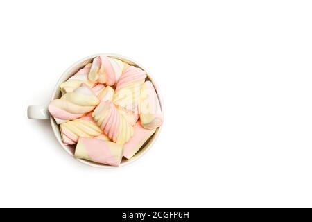 Yellow and pink marshmallows in a cup and on a white  background Stock Photo