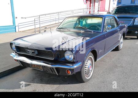A blue 60s Ford Mustang parked in the port area in San Francisco, USA Stock Photo