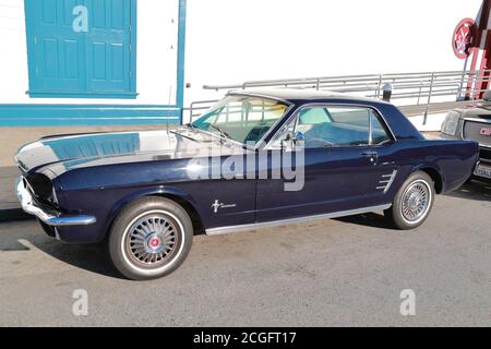 A blue 60s Ford Mustang parked in the port area in San Francisco, USA Stock Photo