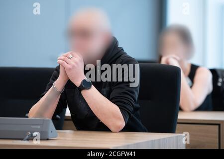 Dresden, Germany. 11th Sep, 2020. Two defendants sit in the hearing room of the Higher Regional Court (OLG) before the start of the trial. The four defendants are alleged to have been alleged members and supporters of the extreme right-wing 'Gruppe Freital'. Credit: Sebastian Kahnert/dpa-Zentralbild/dpa - ATTENTION: Defendants have been disguised for legal reasons, on the instructions of the lawyer or lawyers./dpa/Alamy Live News Stock Photo