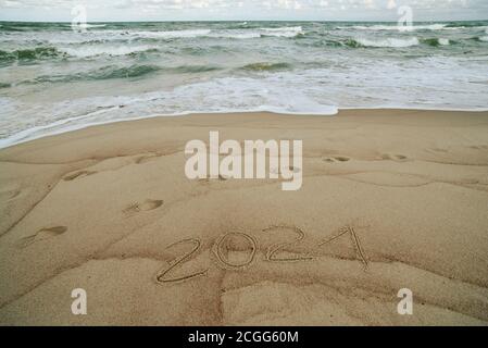 2021 inscription written on the sand, New Year is coming concept Stock Photo