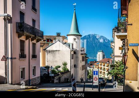 Montreux Switzerland , 5 July 2020 : Montreux old town sloped street view with ancient houses and lake in background in Montreux Switzerland Stock Photo