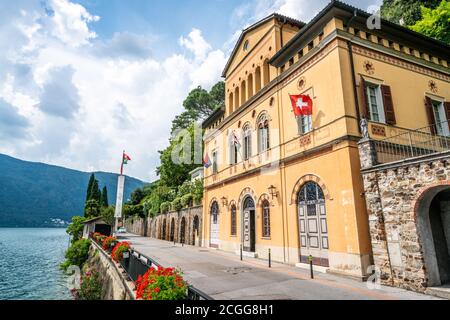 Morcote Switzerland , 1 July 2020 : Morcote town hall orange building on the shore of Lake Lugano in Morcote Ticino Switzerland