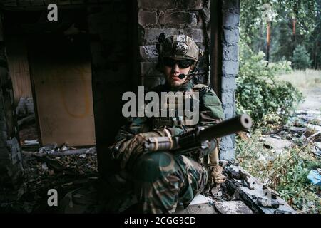 Close-up of a professional fully equipped soldier looking at camera. Stock Photo