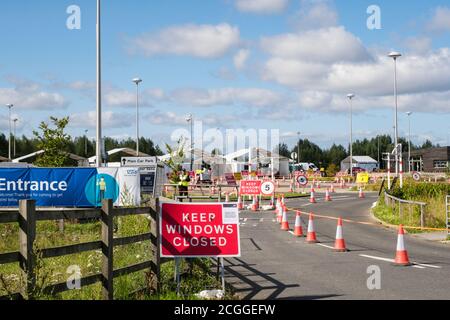 Entrance with signs to Covid-19 drive through testing centre site NHS coronavirus test and trace facility in York, Yorkshire, England, UK, Britain Stock Photo