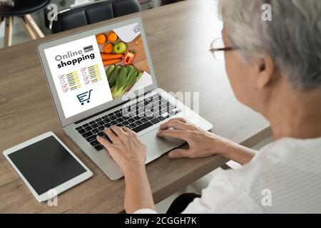 woman using mobile  order delivery food to home older senior female shopping online, using apps Stock Photo