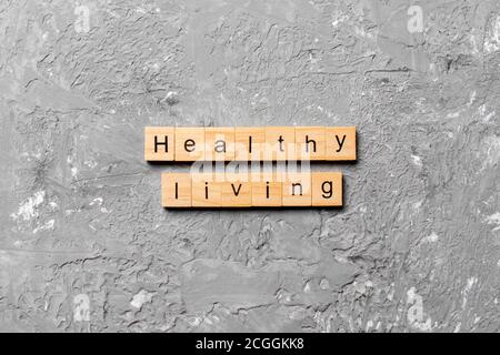 Healthy Living word written on wood block. Healthy Living text on cement table for your desing, concept. Stock Photo