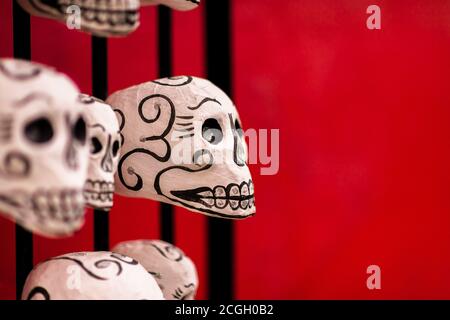 Hand-painted skulls (Calaveras) are seen placed on a street door during the Day of the Dead celebrations in Oaxaca, Mexico. Stock Photo