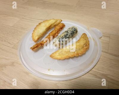 Twigim - Korean style deep fried food. Mandu - Korean dumpling. Gimmari - Seaweed spring rolls stuffed with glass noodle. Eomuk, or Oden - Fish cake. Stock Photo