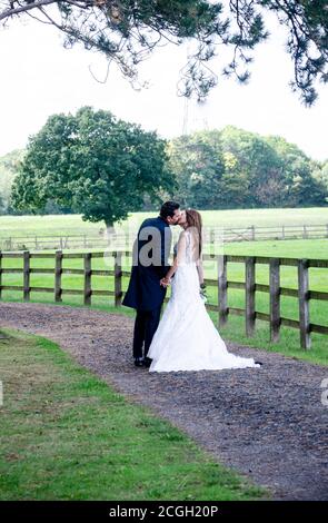 Bride and groom about to kiss Stock Photo - Alamy