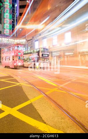 Central District, Hong Kong Island, Hong Kong, China, Asia - Tram and bus at Central Hong Kong with light trails. Stock Photo