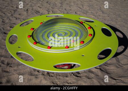 Play device UFO seesaw. A yellow plate with an acrylic cover that is attached with red half-balls. Stock Photo