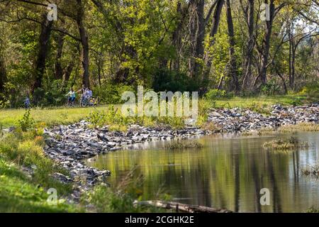 Family outing on the Erie Canalway Trail, bicycling by the Mohawk River at German Flatts, New York. Stock Photo