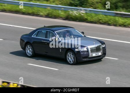 54B A 2010 Rolls Royce Ghost V12 Purple Car Saloon Petrol driving on the M6 motorway near Preston in Lancashire, UK Stock Photo