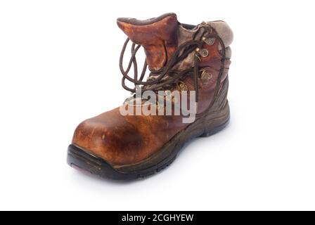 Studio shot of an old dirty walking boot cut out against a white background - John Gollop Stock Photo