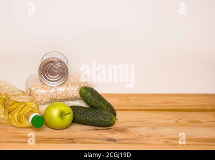 Food donations with copy space. Butter, cereals, canned food on the table. Stock Photo