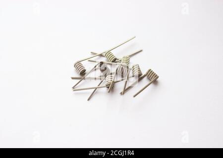 E-cigarette coils on a white background. Metal components for VAPE, consumables. Stock Photo