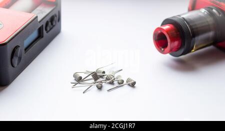 E-cigarette coils on a white background. Metal components for VAPE, consumables. Part of the VAPE on the side Stock Photo