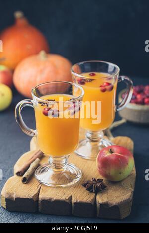 Spicy hot pumpkin punch or sangria in a glass with apple, cinnamon, anise. Halloween and Thanksgiving. Traditional autumn, winter drinks and cocktails Stock Photo