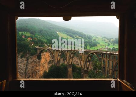 Old big bridge in Durdevica and fantastic view Tara river gorge - is the biggest one canyon in Europe in the national park Durmitor, Montenegro. Balka Stock Photo