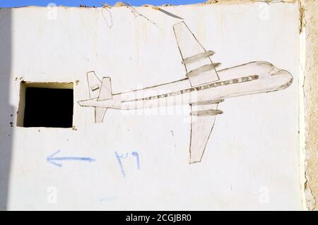 A graffiti drawing of an airplane on a wall in the Saharan village of Farafra Oasis, in the Western Desert of the Sahara, New Valley, Egypt. Stock Photo