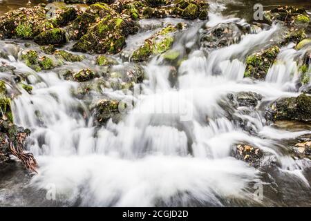 A small cascade in a stream in the Lake District near Coniston Water. Stock Photo