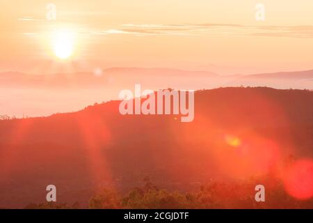 Golden sunrise shines over mountain range. Doi Inthanon National Park, the highest mountain in Chiang Mai, Thailand. Stock Photo