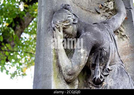 Funerary sculpture of mourning woman at one of the Magnificent Seven Victorian cemeteries Kensal Green Cemetery, London, UK