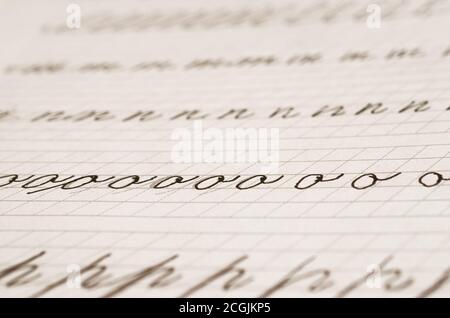 Page of a school notebook with handwritten letters of the English alphabet in close-up Stock Photo