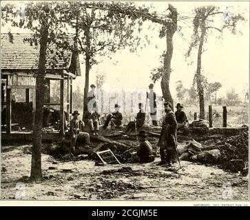 . The photographic history of the Civil War : in ten volumes . VIRGINIA—FEDERAL PICKET STATION NEAR BULL RUN, 1862. GEORGIA—PICKETS JUST BEFORE THE BATTLE OF ATLANTA, JULY 22, 1804 regular sentinels are onduty with keenly observanteyes. When their tour ofduty has been completedthey will be relieved bysome of the men who are somuch at ease. The picketsretreated before any ad-vance in face of the Con-federates, and rejoined themain body of troops. Inthe Atlanta photograph,the reserve post isslightly in the rear of theouter line of pickets. Judg-ing from the rough earth-works, the dilapidatedhous Stock Photo