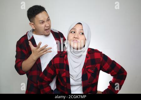 Portrait of Asian muslim couple husband and wife having fight, argue on each other, bad relationship in marriage concept