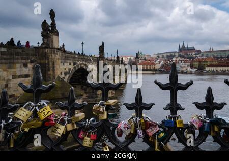 Love padlocks on a bridge in Prague with the old town in the background, Czech Republic Stock Photo