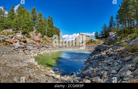 View of mountains, glacier and lakes. The Miage glacier landscape in summer. The Miage glacier is a glacier in the Aosta Valley that descends from Mon Stock Photo