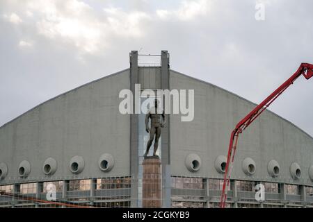 Monument to Ivan Yarygin, Olympic champion in freestyle wrestling, against the background of the Palace of Sports in Krasnoyarsk city. Stock Photo