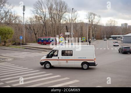 A special emergency rescue vehicle of the Ministry of Emergency Situations, with the inscription 'Lifeguard' is driving down the street on a cloudy au Stock Photo