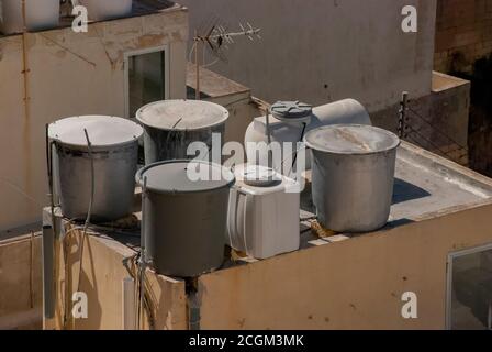 Water tanks on the roof tops of a building in a town in Malta Stock Photo