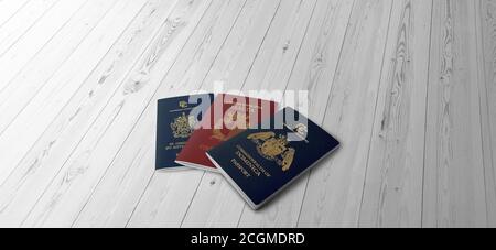 Three passports on a wooden table Dominica, Malta, Saint Kitts and Nevis, Citizenship by Investment Stock Photo