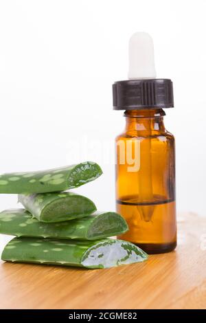 Aloe vera plant with fresh drops and dropper glass bottle. Collagen serum pack mockup. Beauty cosmetic product ads poster template. isolated backgroun Stock Photo