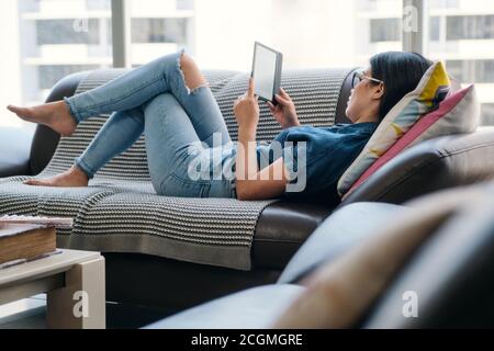 Young Woman Holding Ereader And Reading Ebook Stock Photo