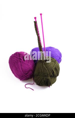 Three colorful balls of wool with knitting needles Stock Photo