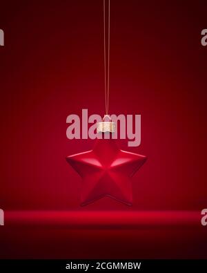 Burgundy red matt Christmas ornament. Five-pointed star bauble hanging on golden string. Red background. Christmas decoration, festive atmosphere conc Stock Photo