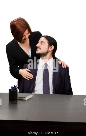 View of a business couple with a woman behind a seated man Stock Photo