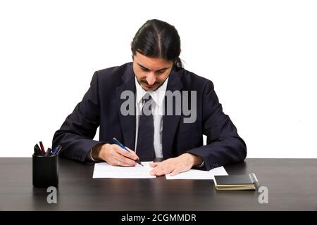 Serious Businessman Writing a Letter at his Desk Stock Photo