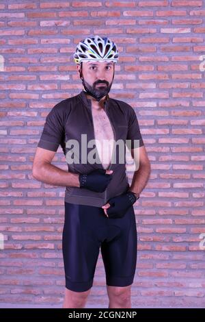 Young male cyclist dressing up looking at camera Stock Photo