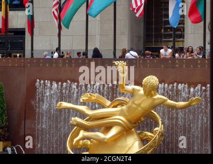 Prometheus statue and flags at Rockefeller Center, New York City, United States Stock Photo