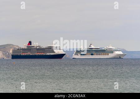 Weymouth, Dorset, UK.  11th September 2020. The empty Cunard and Royal Caribbean cruise ships Queen Elizabeth and Jewel of the Seas anchored in Weymouth Bay in Dorset during the Covid-19 cruising shutdown.  Picture Credit: Graham Hunt/Alamy Live News Stock Photo